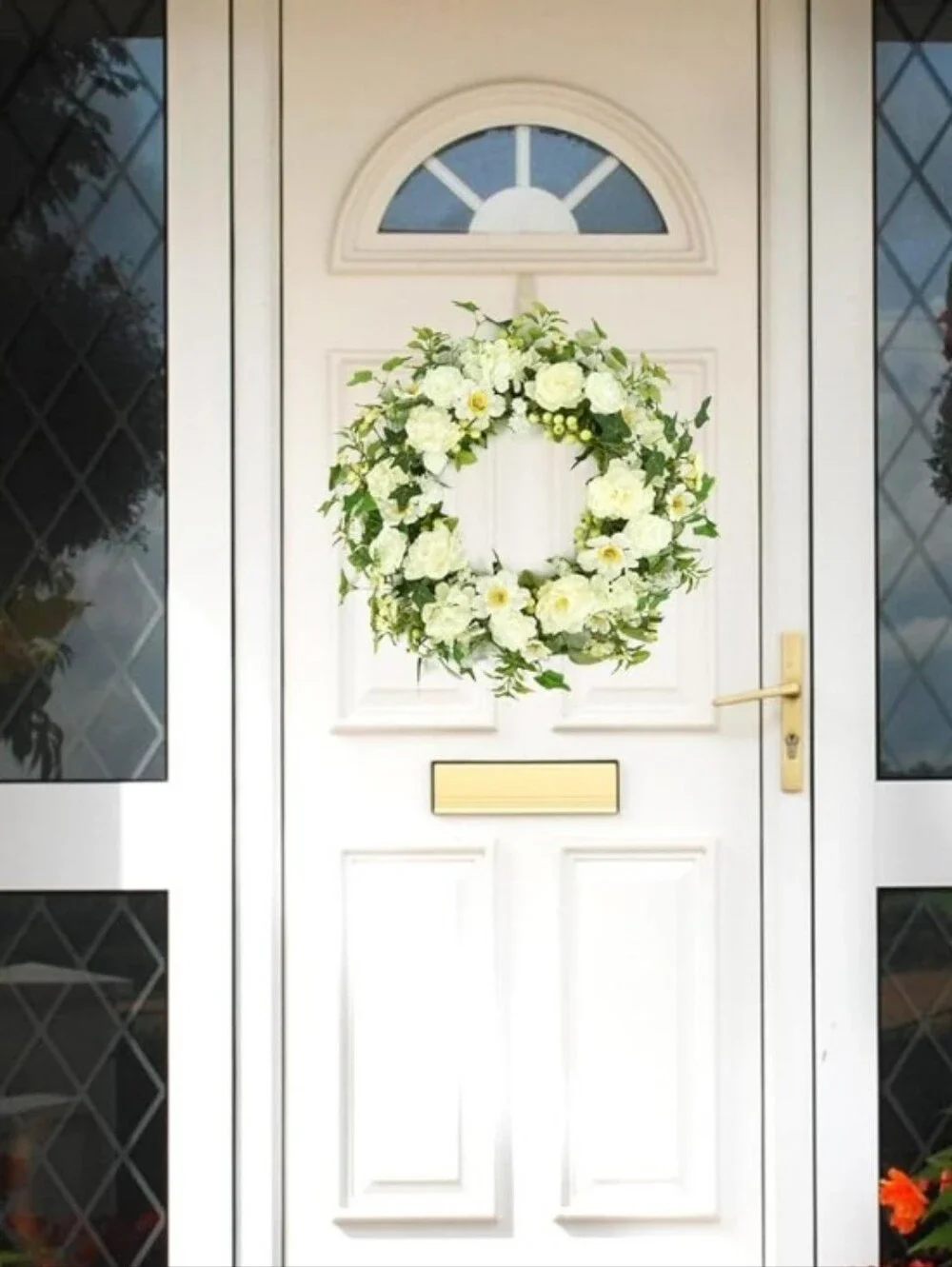 White Front Door with Decorative Green and White Floral Wreath